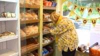 Volunteer restocking fresh bread at Church Fenton Community Shop