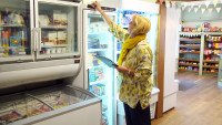 Volunteer checking the fridge temperature at Church Fenton Community Shop